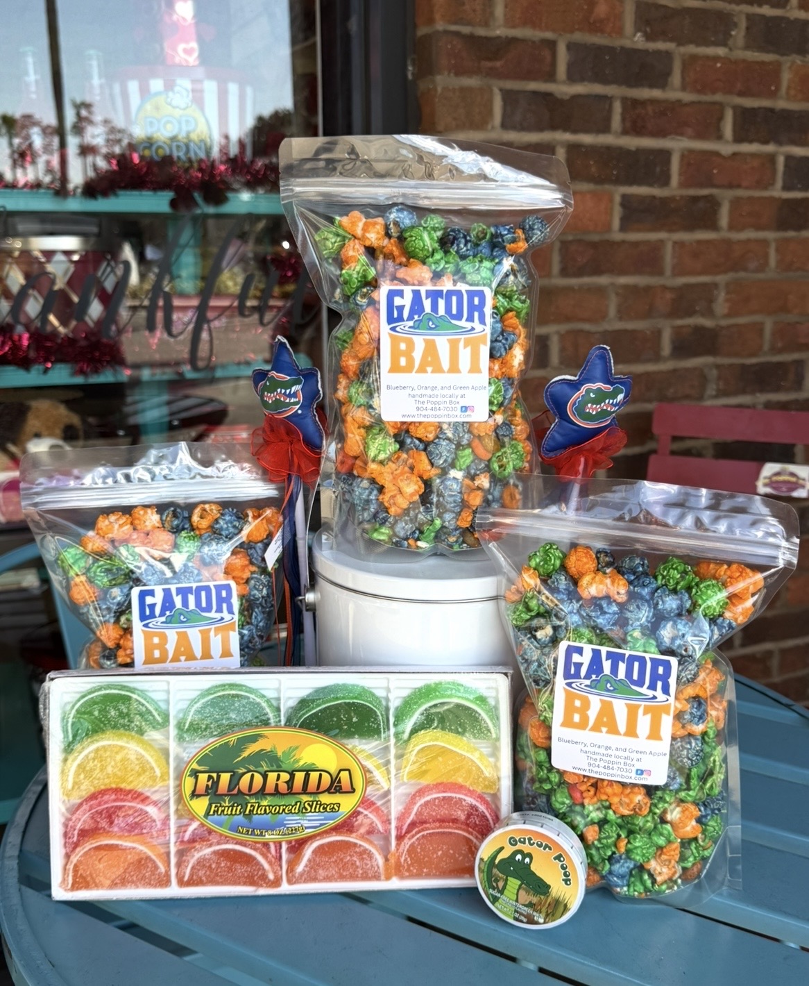 Clear plastic bags of colorful bait with Florida Gator logo, displayed on a table with a brick wall background.