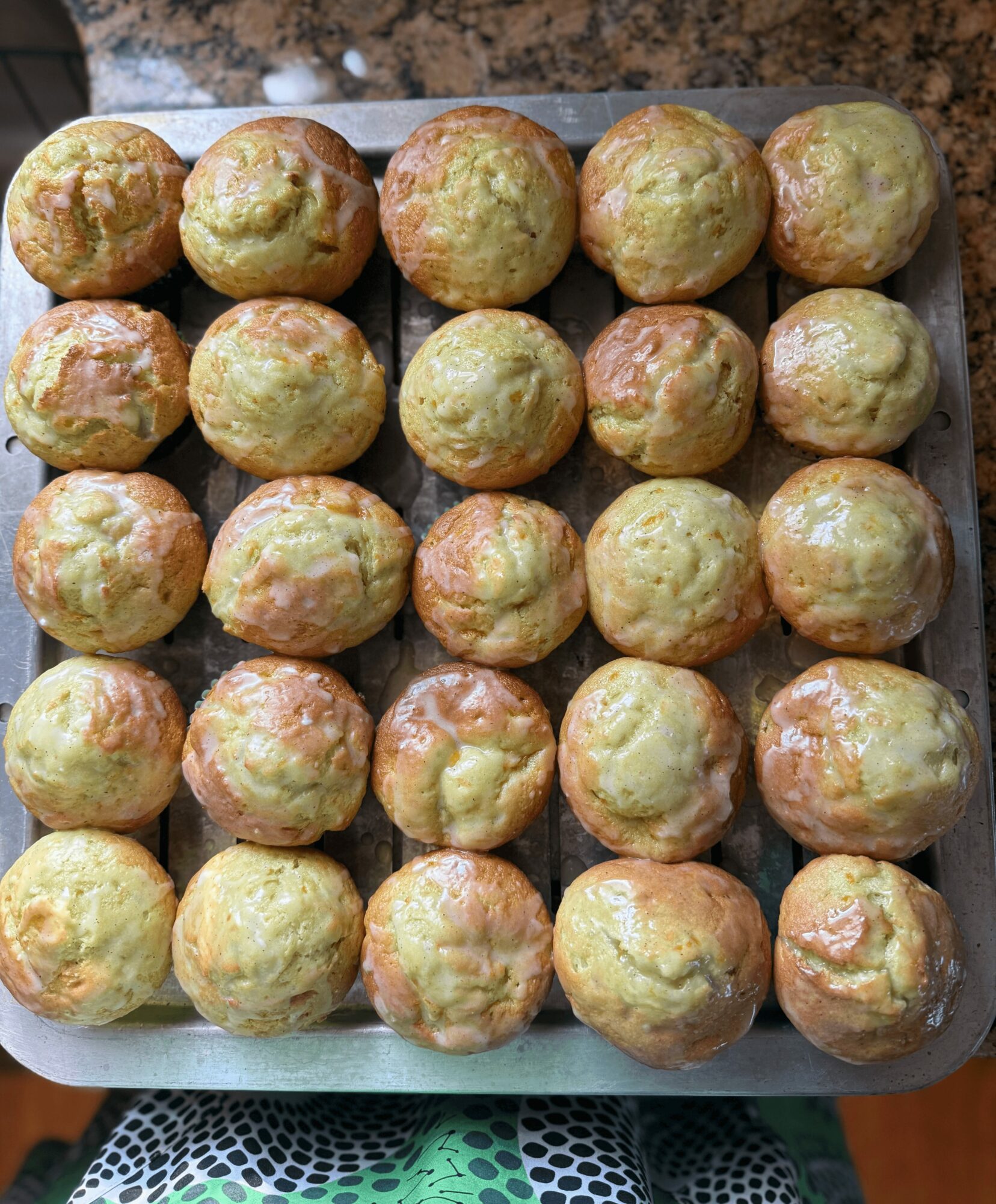Tray of round baked goods with golden-brown tops on a baking sheet.