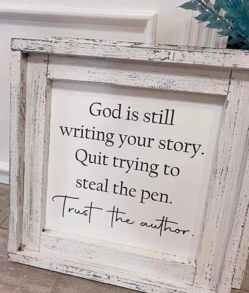 Framed sign with inspirational quote about trusting the author, in a white distressed frame, on a tiled floor.