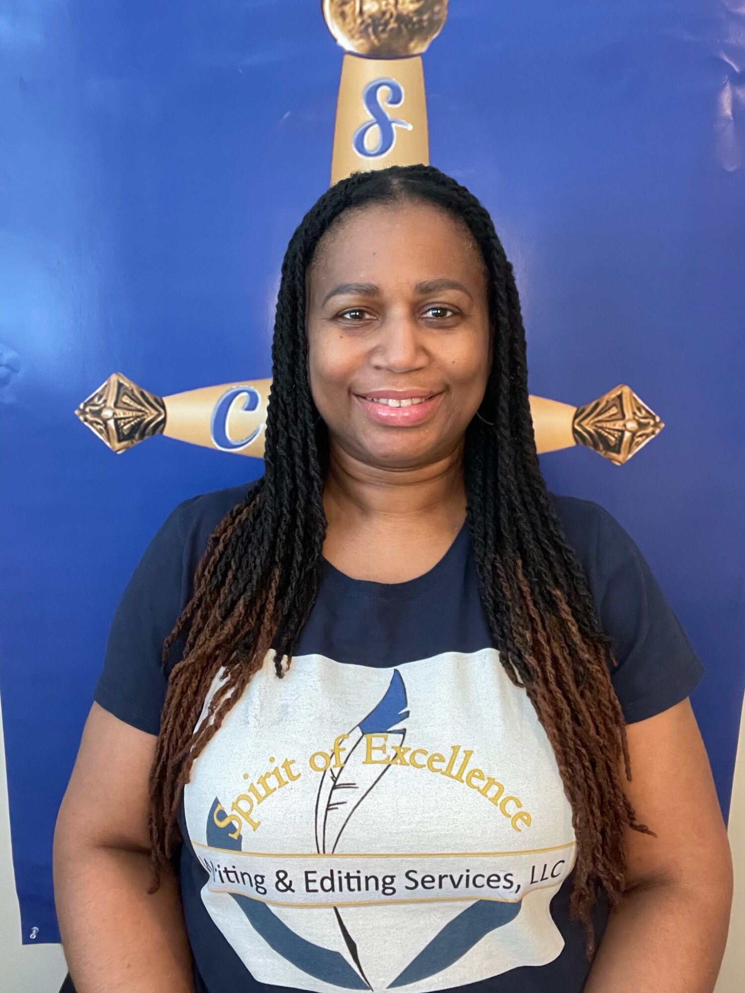 Woman with long braided hair smiling in front of a blue background with a cross and text.
