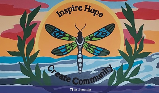 Colorful mural with a dragonfly, sun, and plants, with the words 'Inspire Hope' and 'Create Community'.