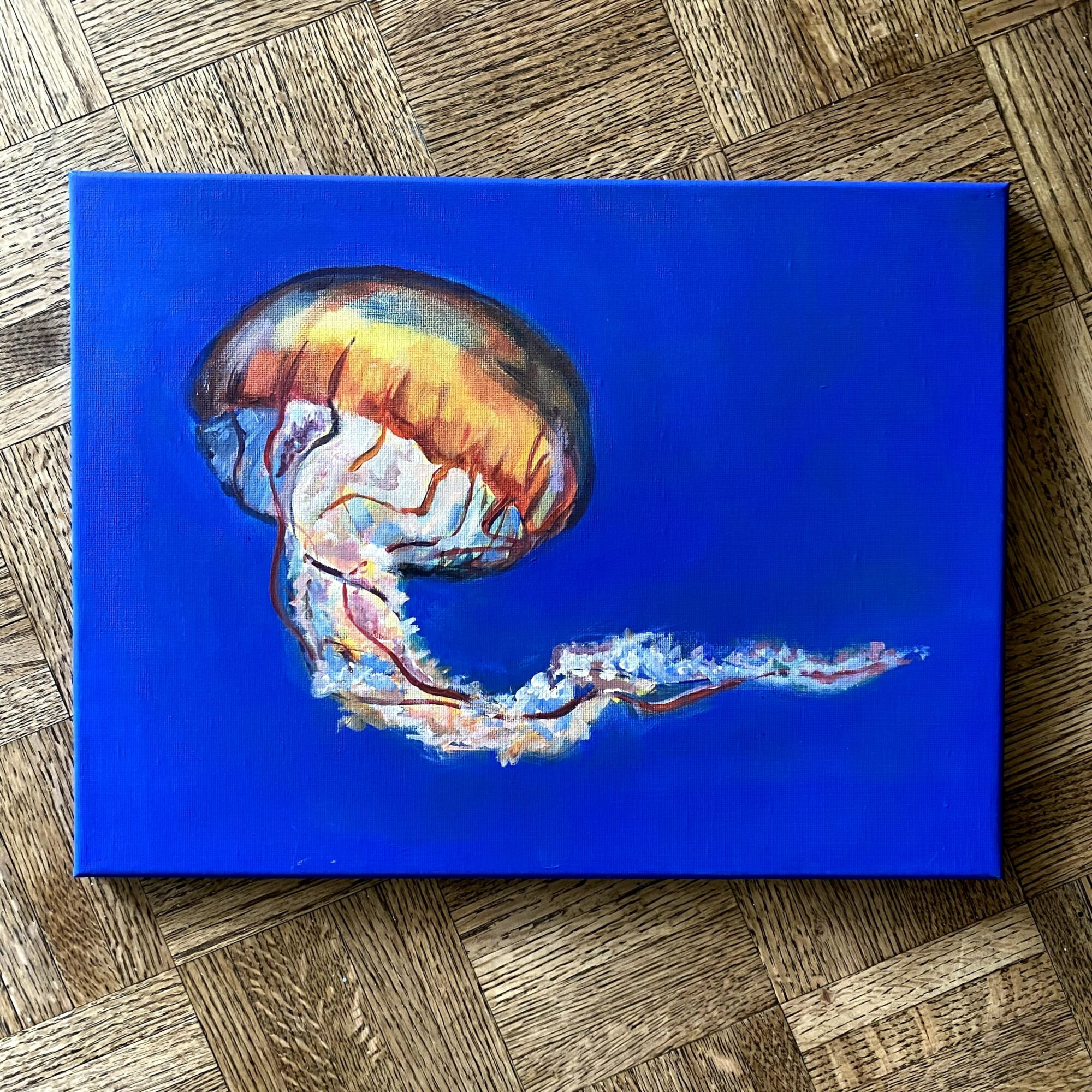 Painting of a jellyfish with a colorful bell and trailing tentacles on a blue background.