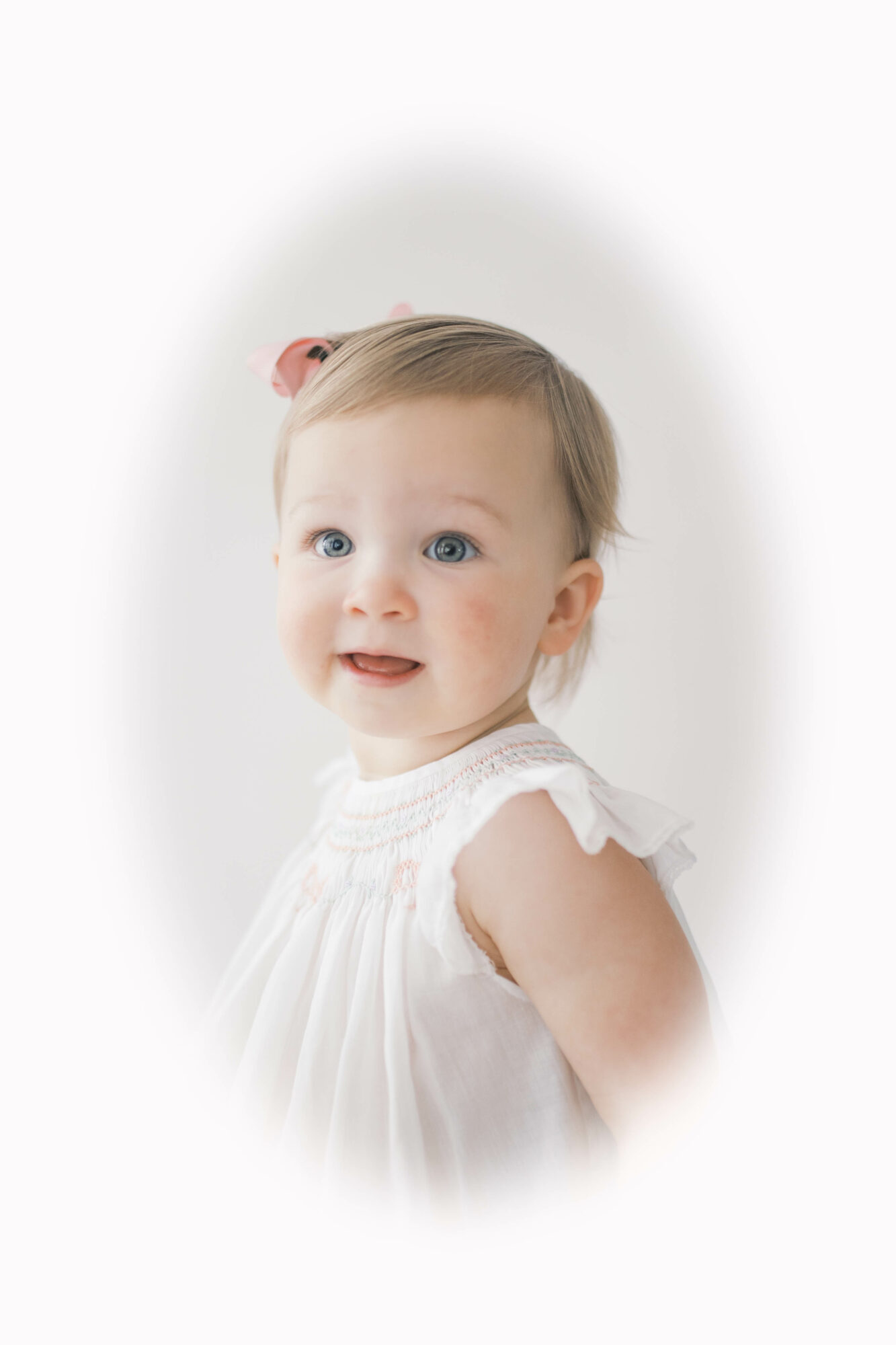 Young girl with light brown hair, blue eyes, wearing a white dress with ruffled sleeves, looking to the side.