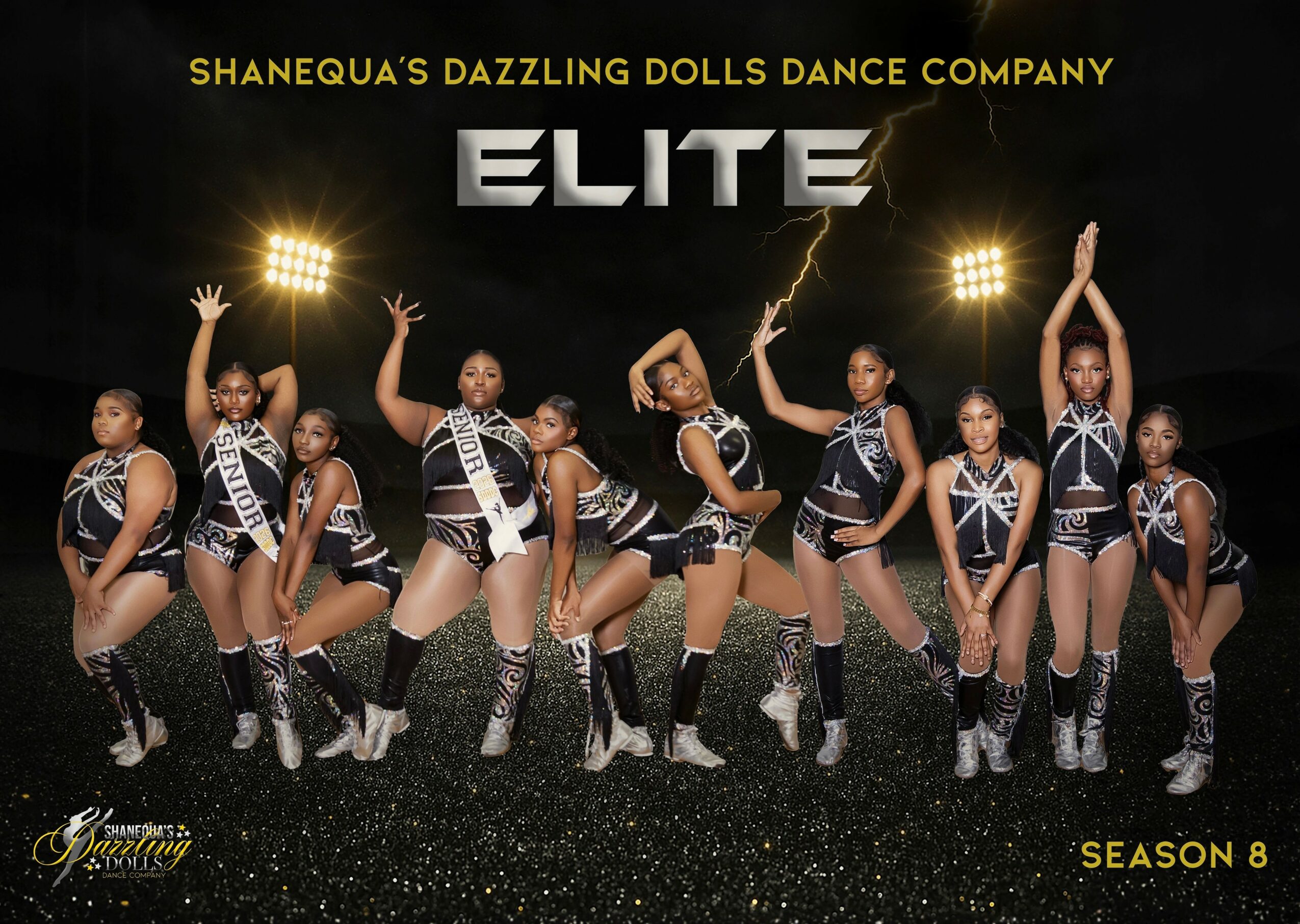 Group of young dancers in black and white costumes perform on stage with lightning effects behind them.