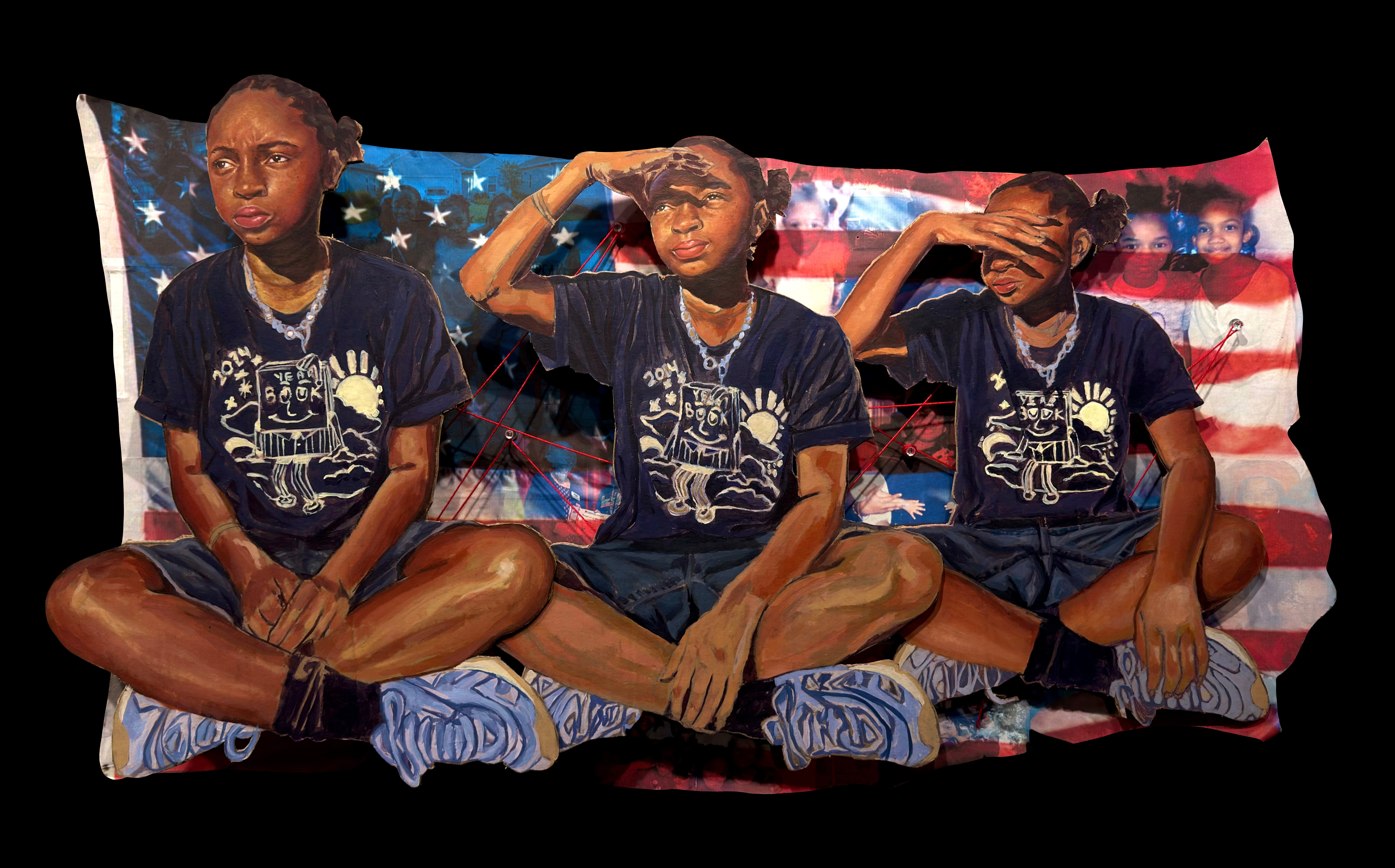 Three children sitting on a flag-patterned blanket, saluting with their right hands, wearing matching dark shirts, shorts, and socks.