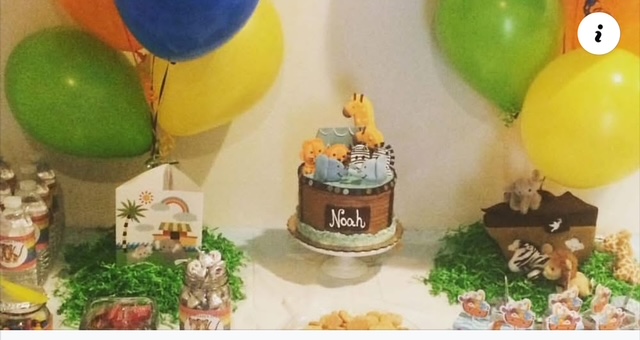 Party table with balloons, a birthday cake, and decorations for a child's celebration.