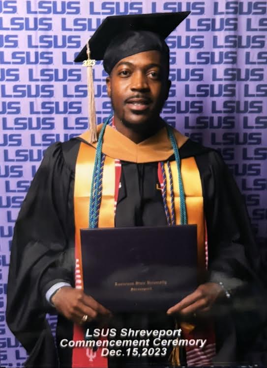 Graduate in cap and gown holding diploma at LSUS Shreveport commencement, background with LSUS logo, date December 15, 2023.