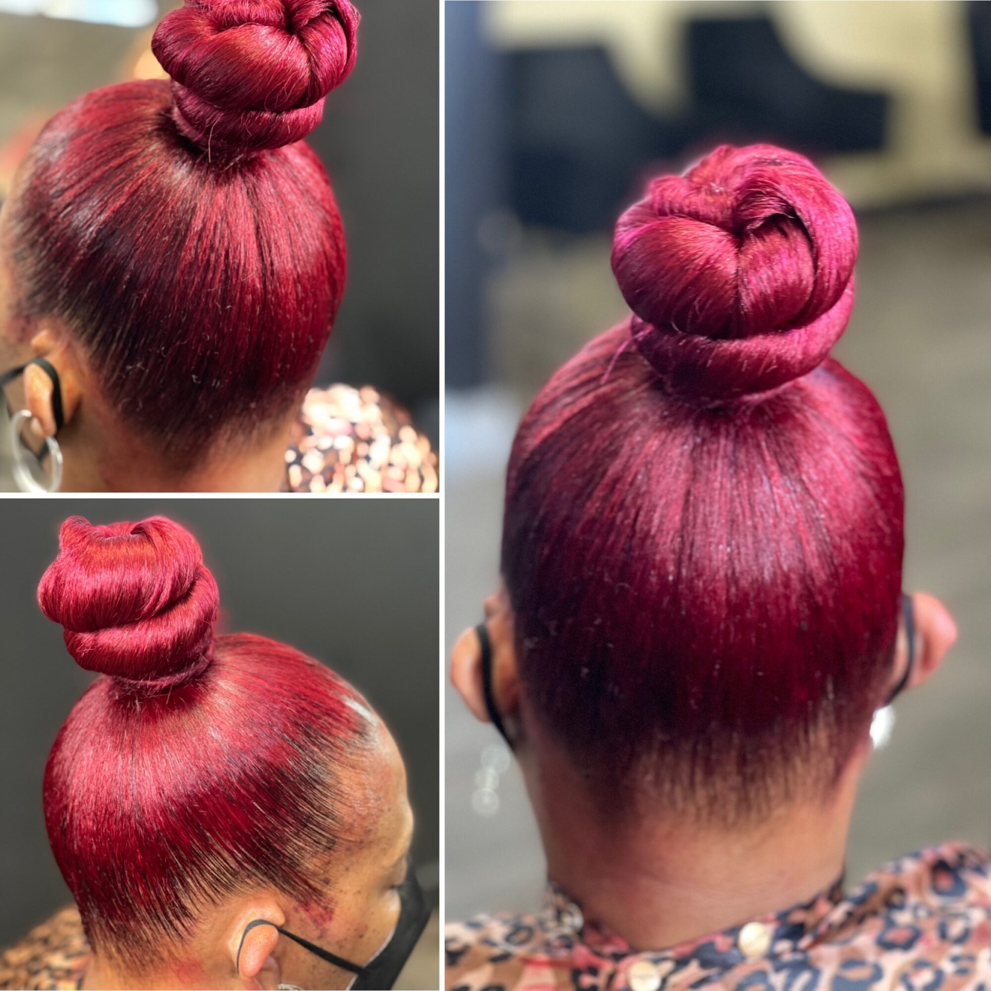 Back view of a person with bright red hair styled in a high bun, wearing a face mask and patterned top.