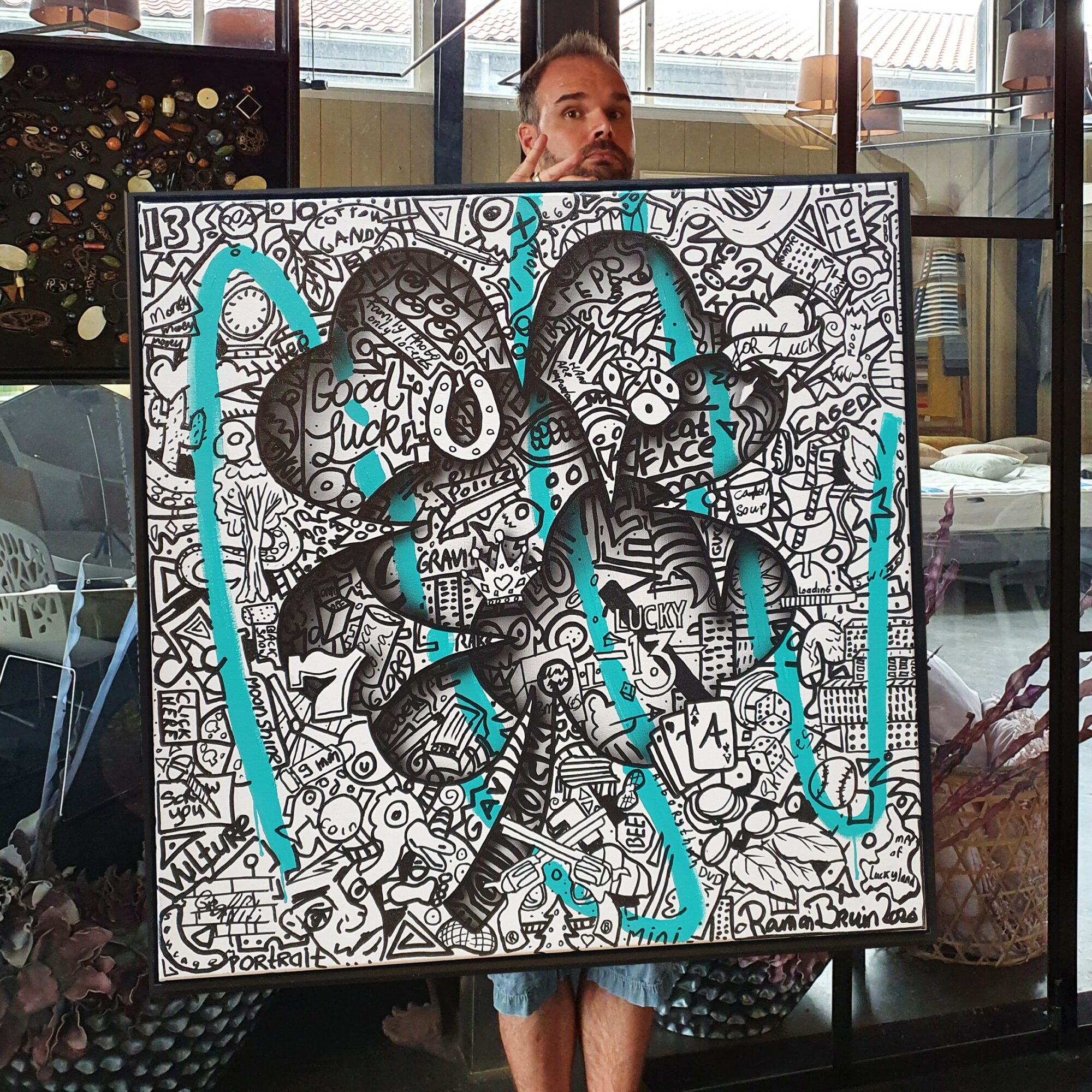 Black and white doodle artwork with blue accents, featuring two stylized faces with headphones, surrounded by various patterns and symbols.