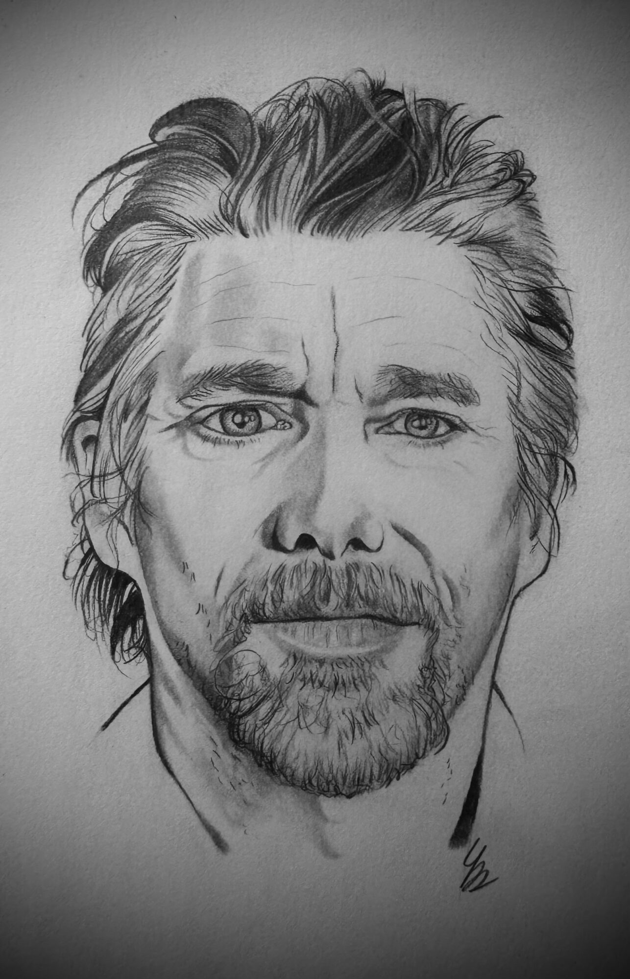 Black and white portrait of a man with wavy hair, beard, and mustache, looking directly at the camera.