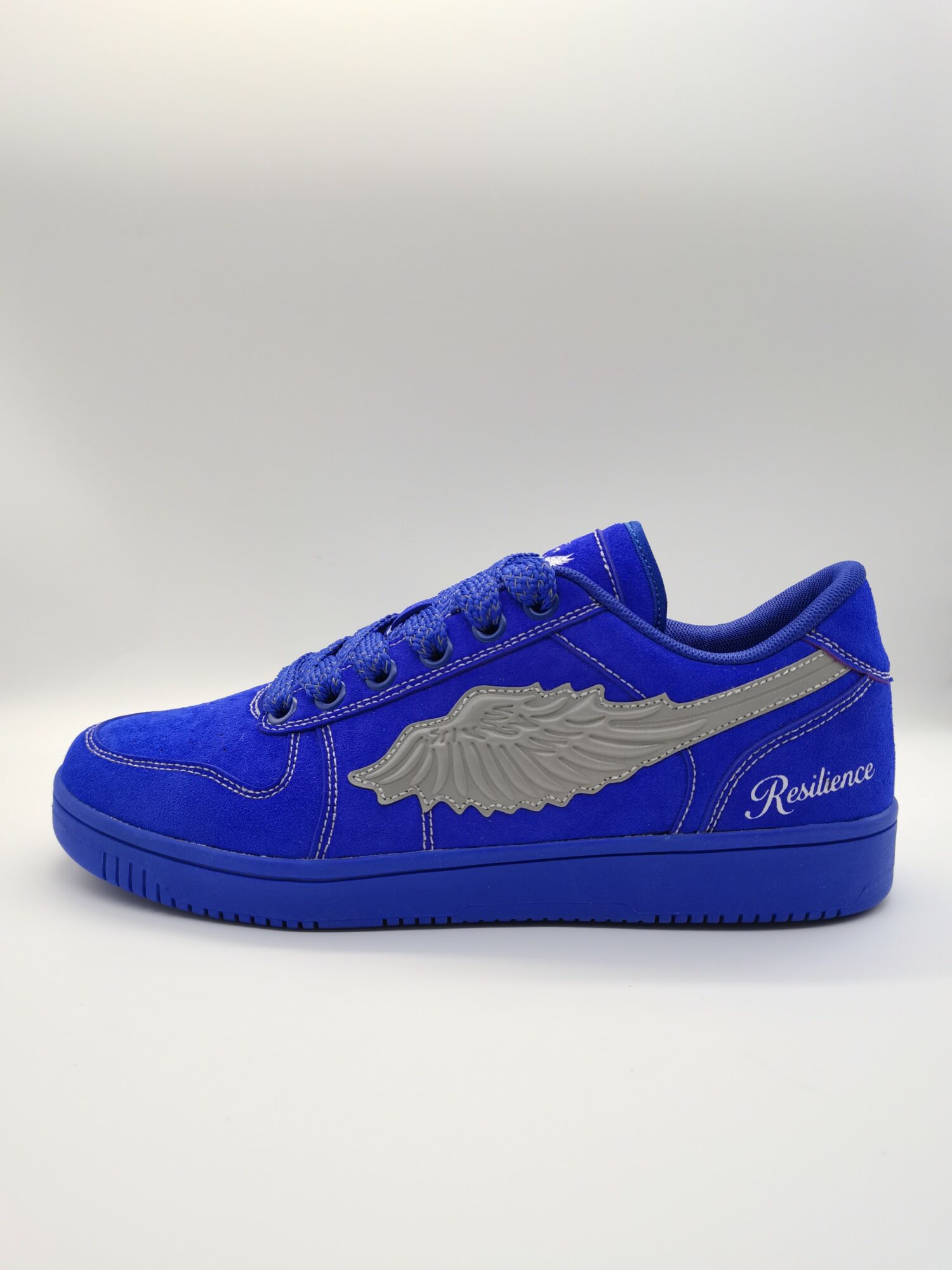 Blue sneaker with a large silver wing design and the word 'Resilience' on the side, against a plain background.