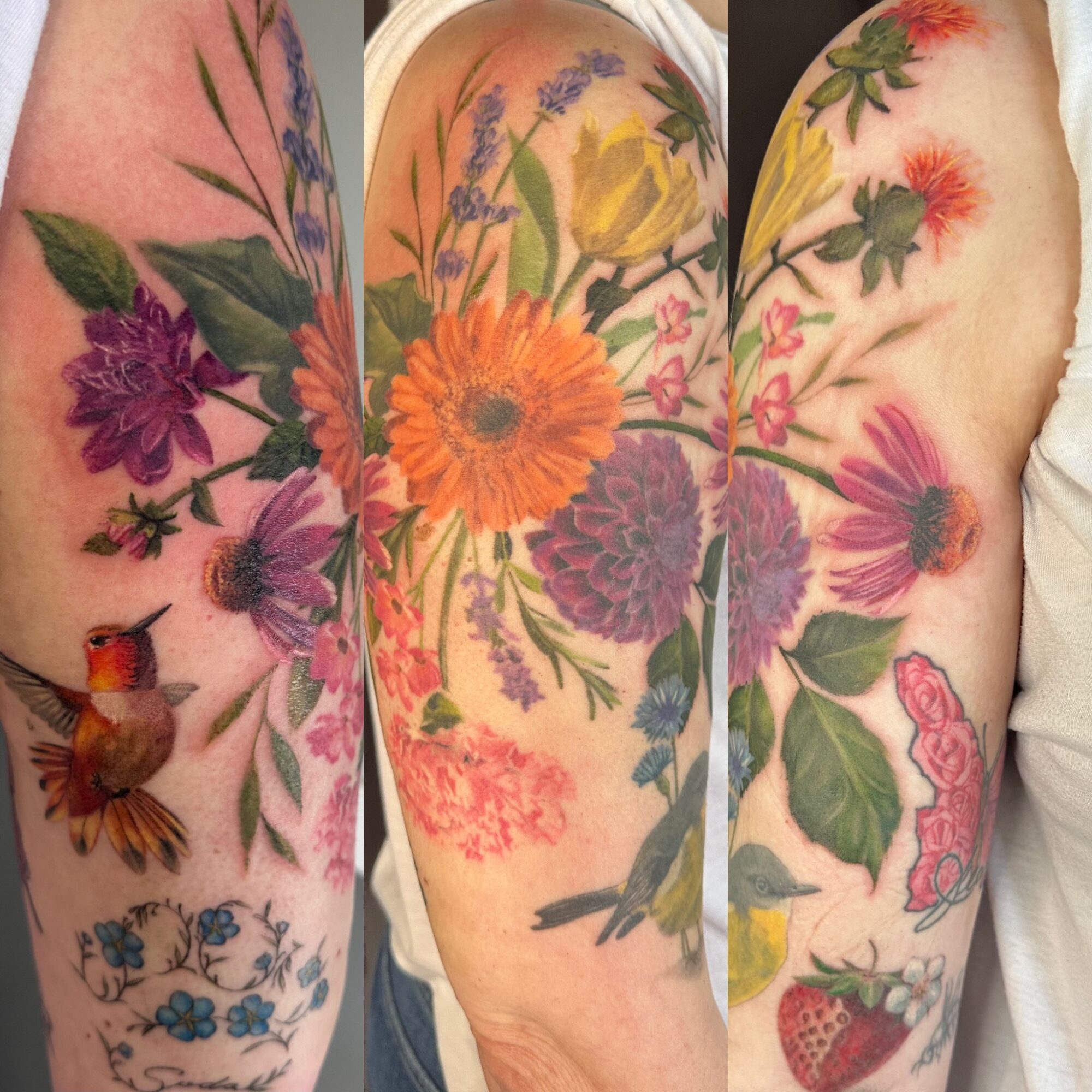 Multiple colorful floral tattoos on person's arm and shoulder, including flowers, leaves, and a strawberry, with detailed shading and vibrant colors.