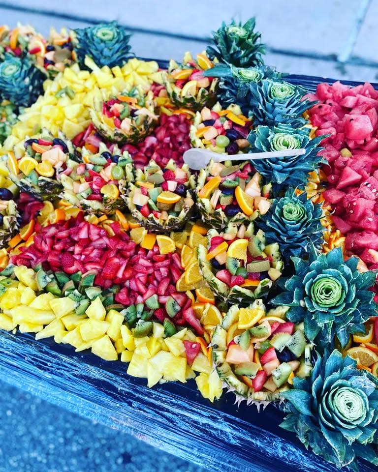 Colorful flower-shaped candies arranged in a decorative pattern on a surface.