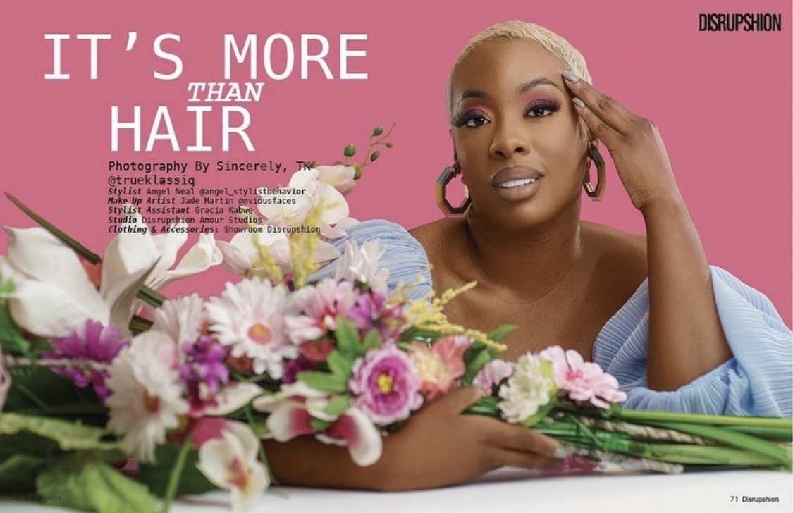 Woman with blonde hair and pink earrings poses with flowers against pink background, text reads 'It's more than hair'.