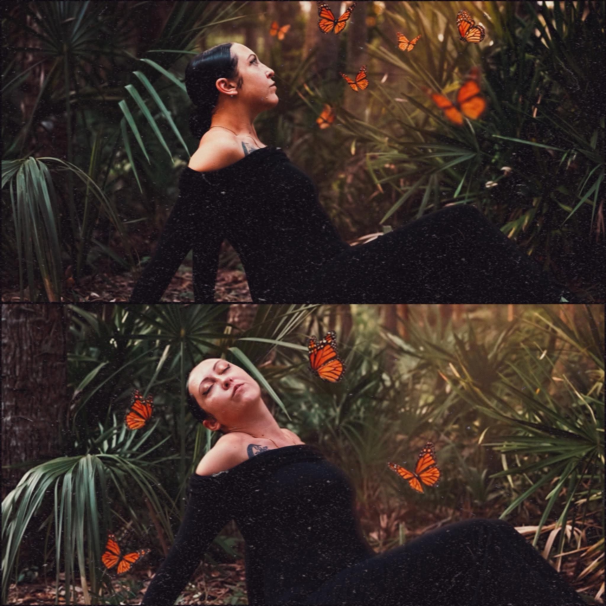 Woman sitting among plants with butterflies around her, looking upward, wearing a black dress.