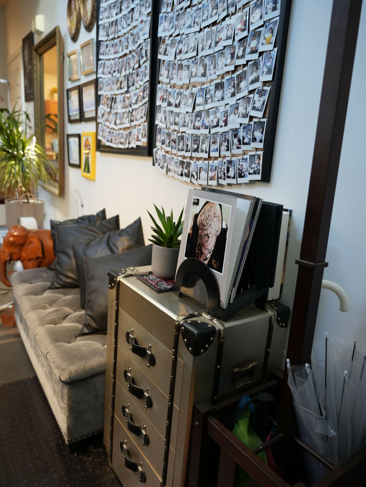 A table with photo collages, a vintage typewriter, and decorative items in a room.