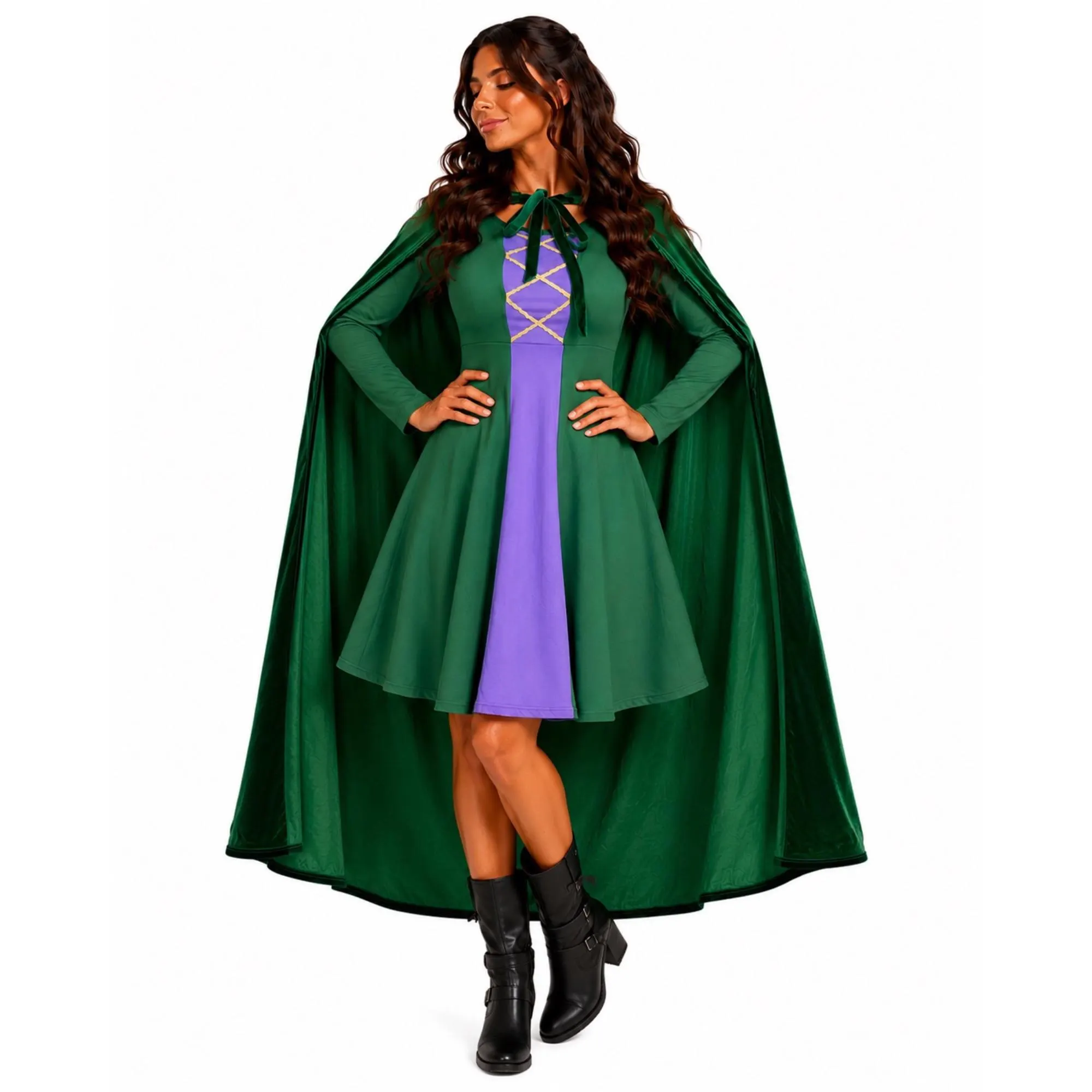 Woman in a green cape and dress with purple accents, standing with hands on hips, smiling, against a white background.