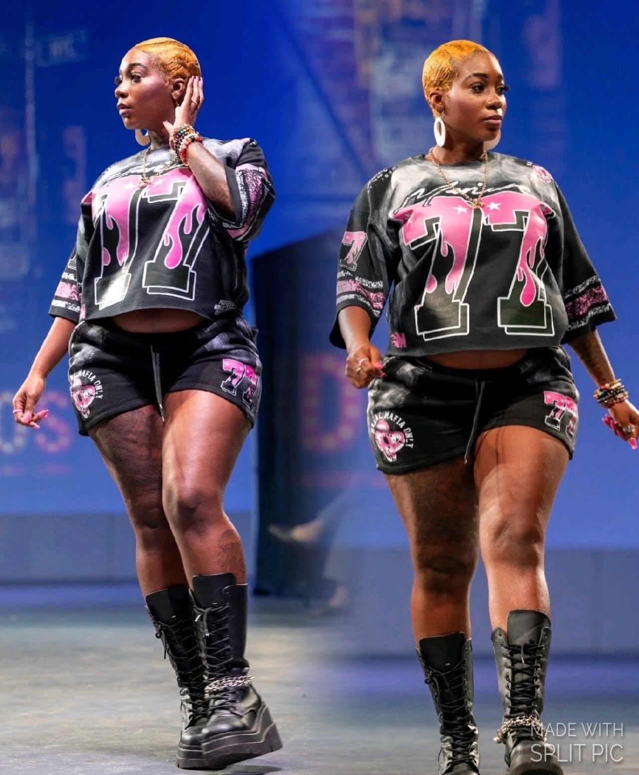 Two women with short blonde hair wearing matching black and pink patterned outfits and black boots, standing on stage.